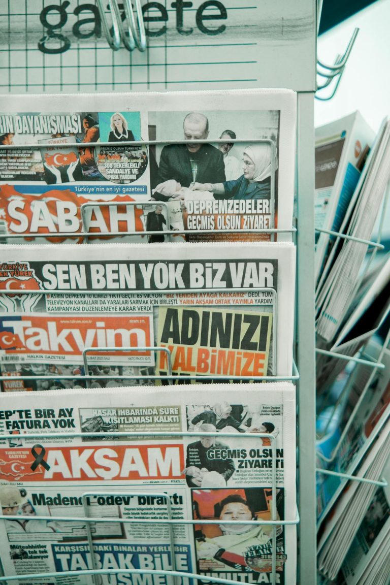 Close-up of Turkish newspapers in a stand with headlines visible.